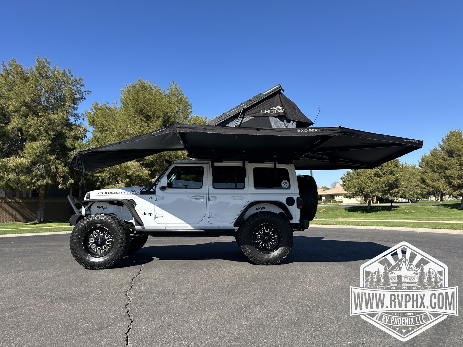 Awning wrapped around the rear and side of the Jeep for full camp shade