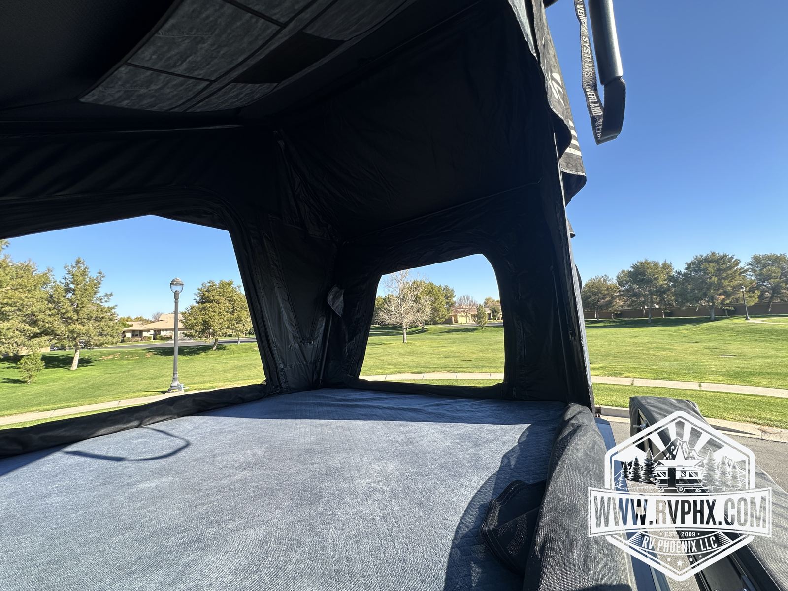 Inside the rooftop tent: mattress with panoramic window openings