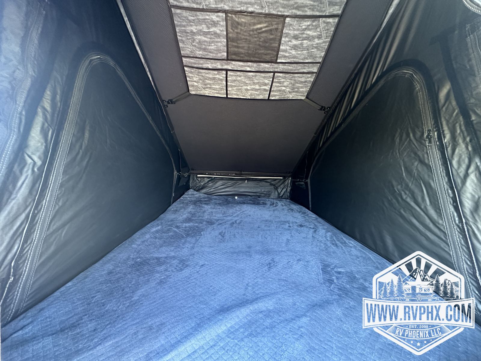 Rooftop tent interior looking toward the mesh skylight panels