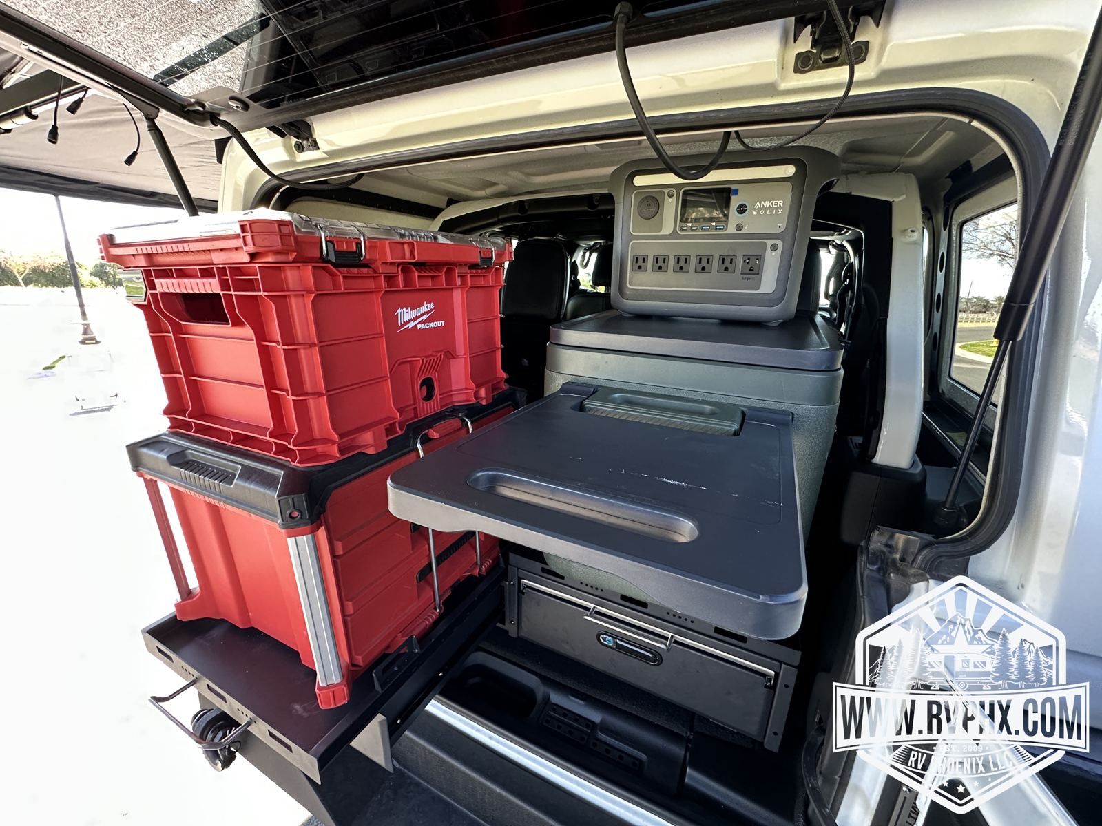 Fold-out rear table with camp power and storage crates